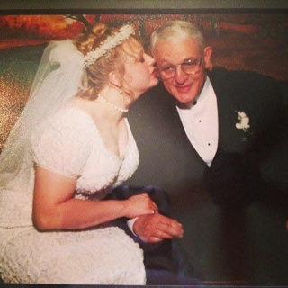 Barbara in wedding gown, kissing Dad (Fred)