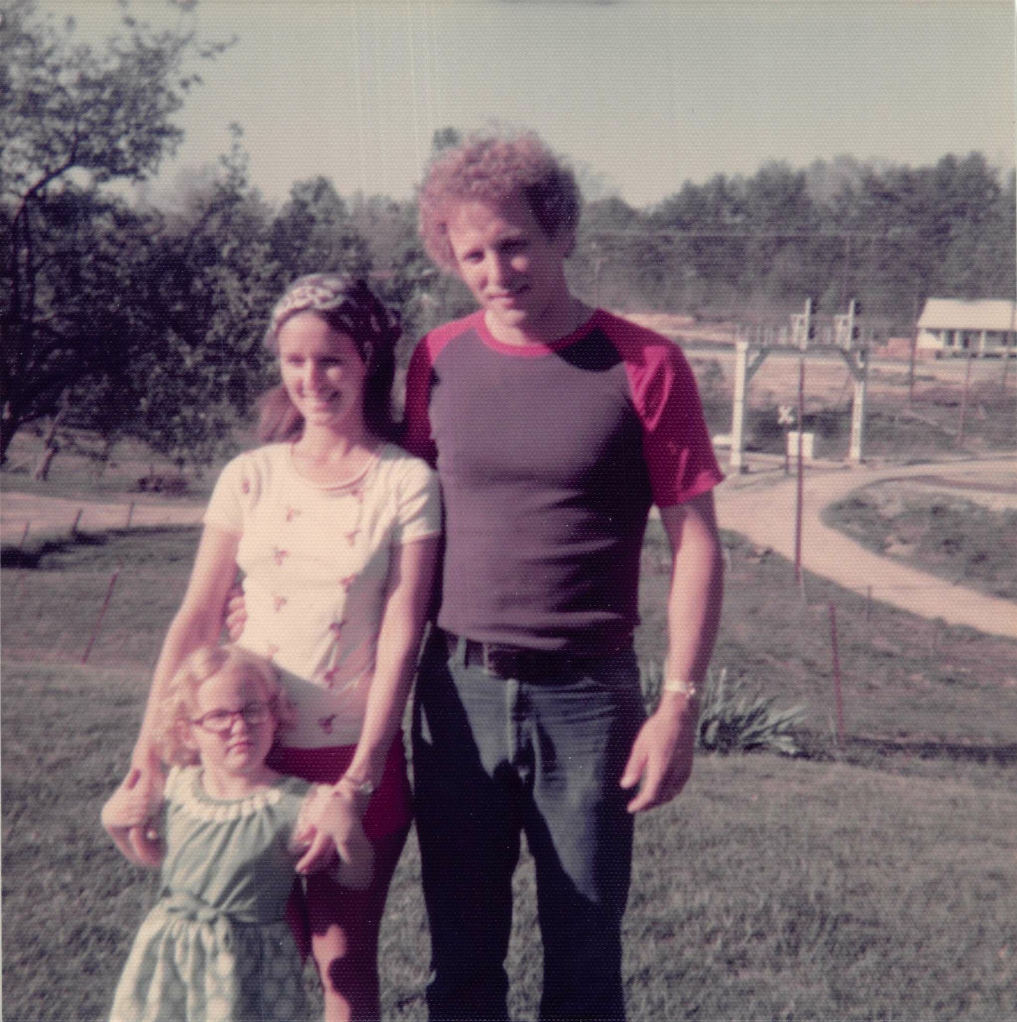 Angela, Donna and John Woodford, outside.